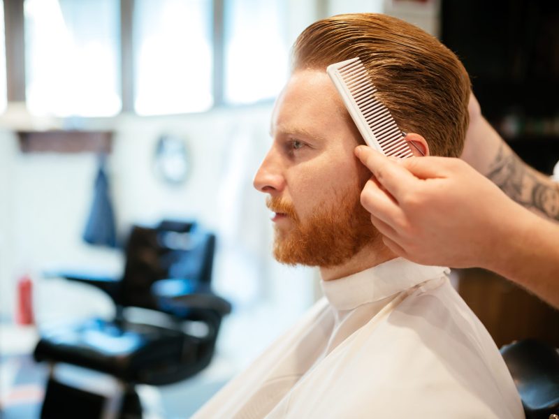 Combing of hair and styling in barber shop