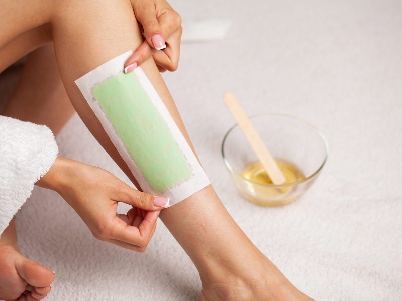 Depilation procedure with wax on the legs.